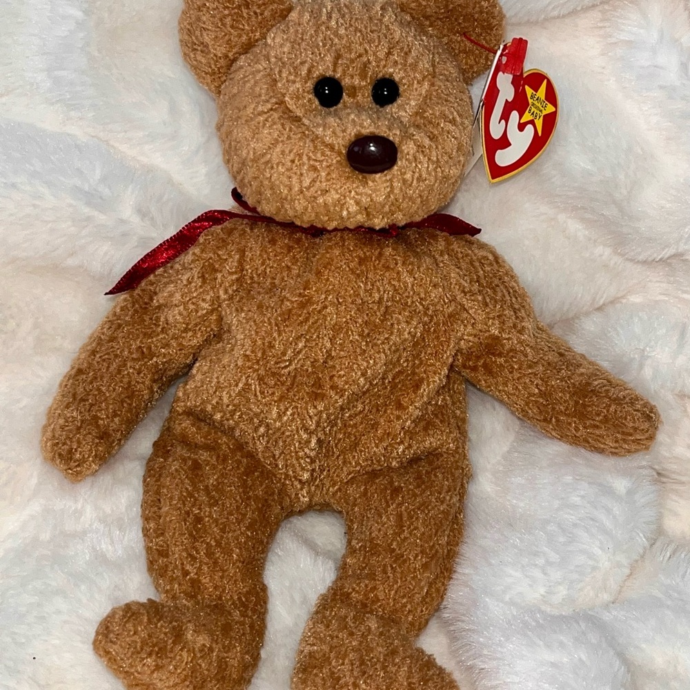 The beanie babies collection Curly Plush Bear with Red Ribbon. Rare tag error.